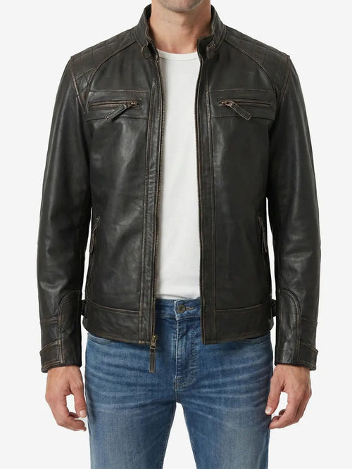 Man wearing a black leather jacket over a white shirt and blue jeans on a white background