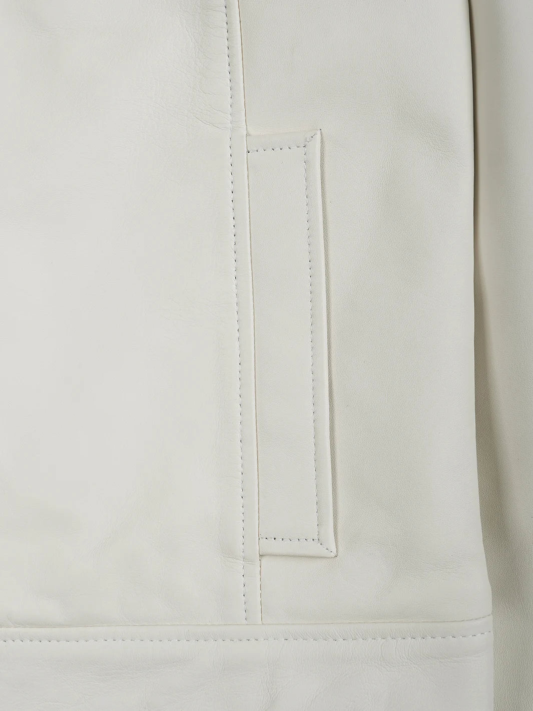 Close-up of a beige with a pocket detail on a light background